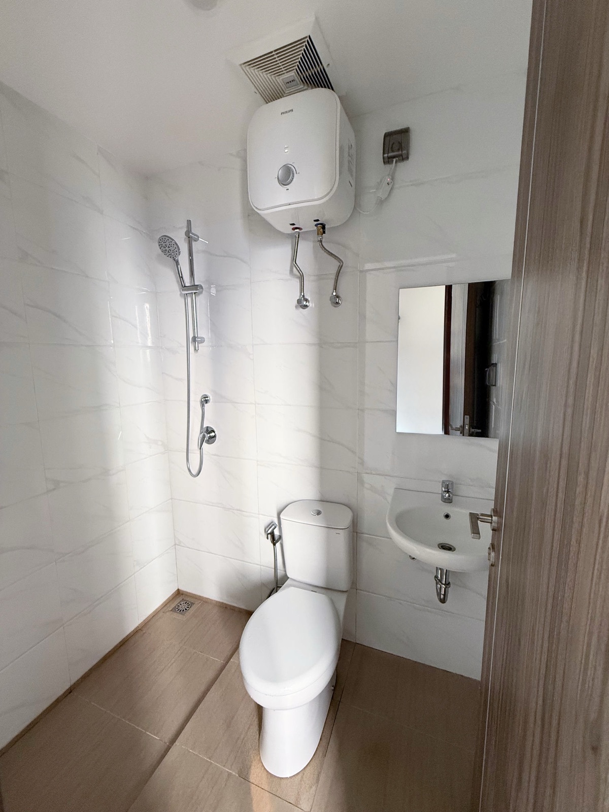 Kamar mandi studio SkyHouse BSD Kensington: shower, kloset duduk, wastafel, dan water heater